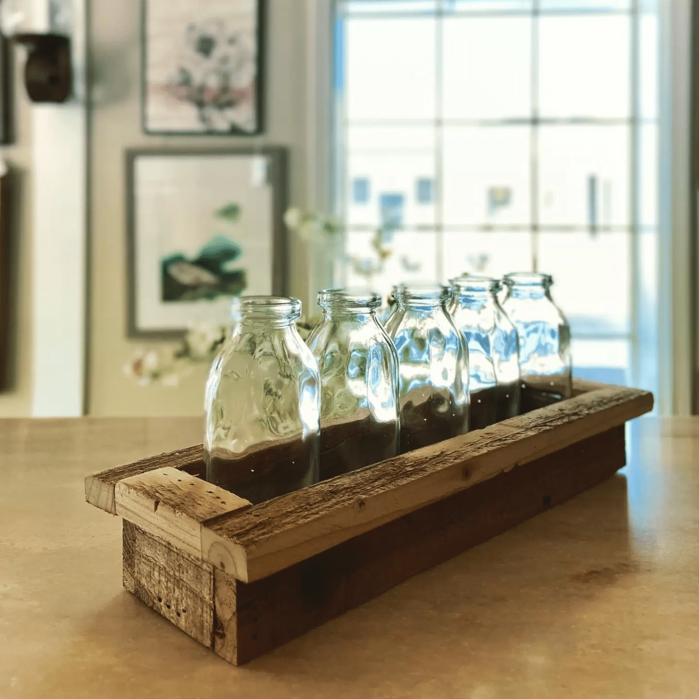 centerpiece with glass bottles and wood