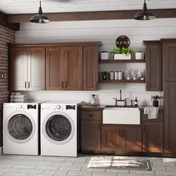 laundry storage cabinets with a brown finish and white washer and dryer combination.